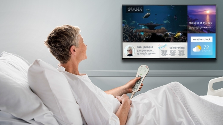 Woman in a hospital bed using IPTV